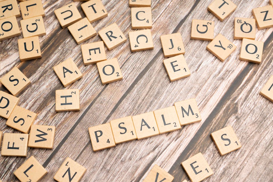 Wooden Scrabble tiles spelling 'Psalm' arranged on a rustic wooden surface, symbolizing creativity and spirituality.