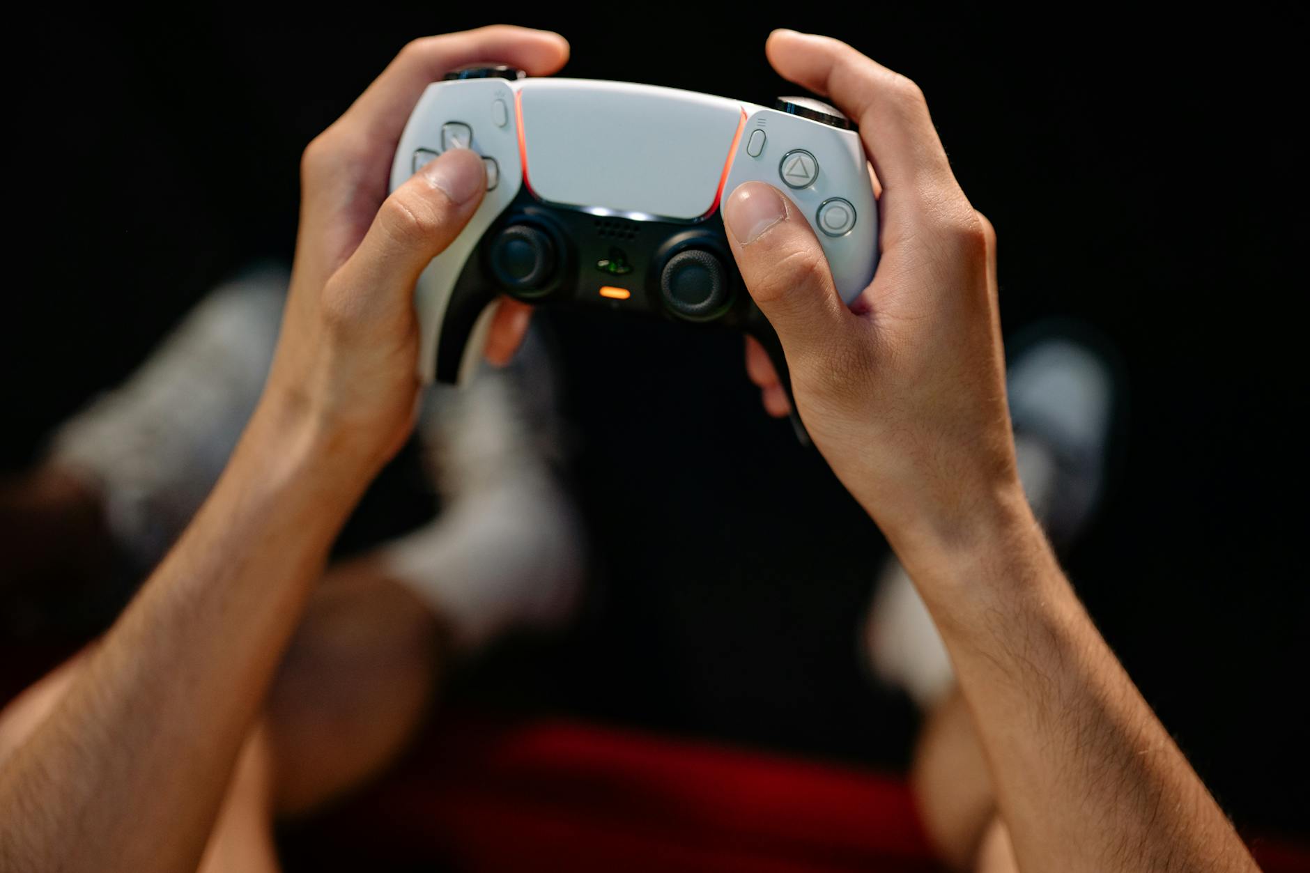 Hands gripping a modern game controller, ready for immersive gaming experience.