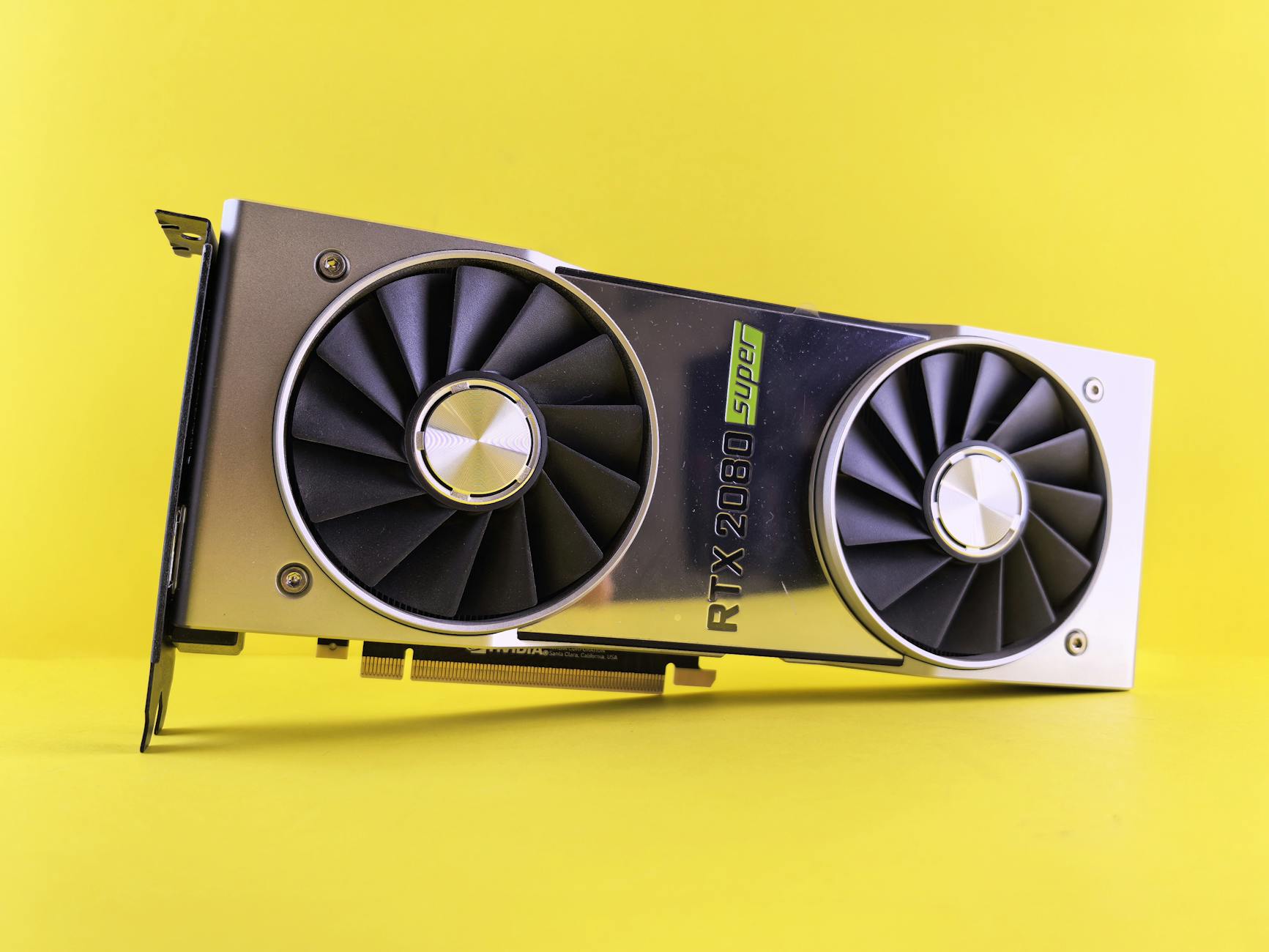 Close-up of a RTX 2080 Super graphics card against a bright yellow backdrop, showcasing high-tech design. – RTX 4070 vs RX