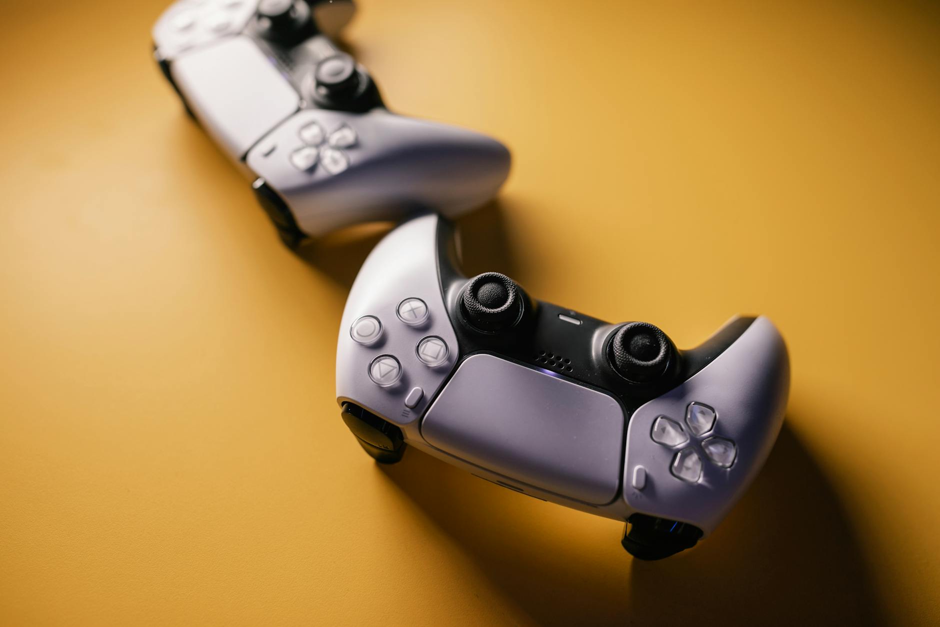 Pair of modern game controllers placed against a vibrant backdrop, emphasizing gaming and technology. – SteelSeries quality control issues