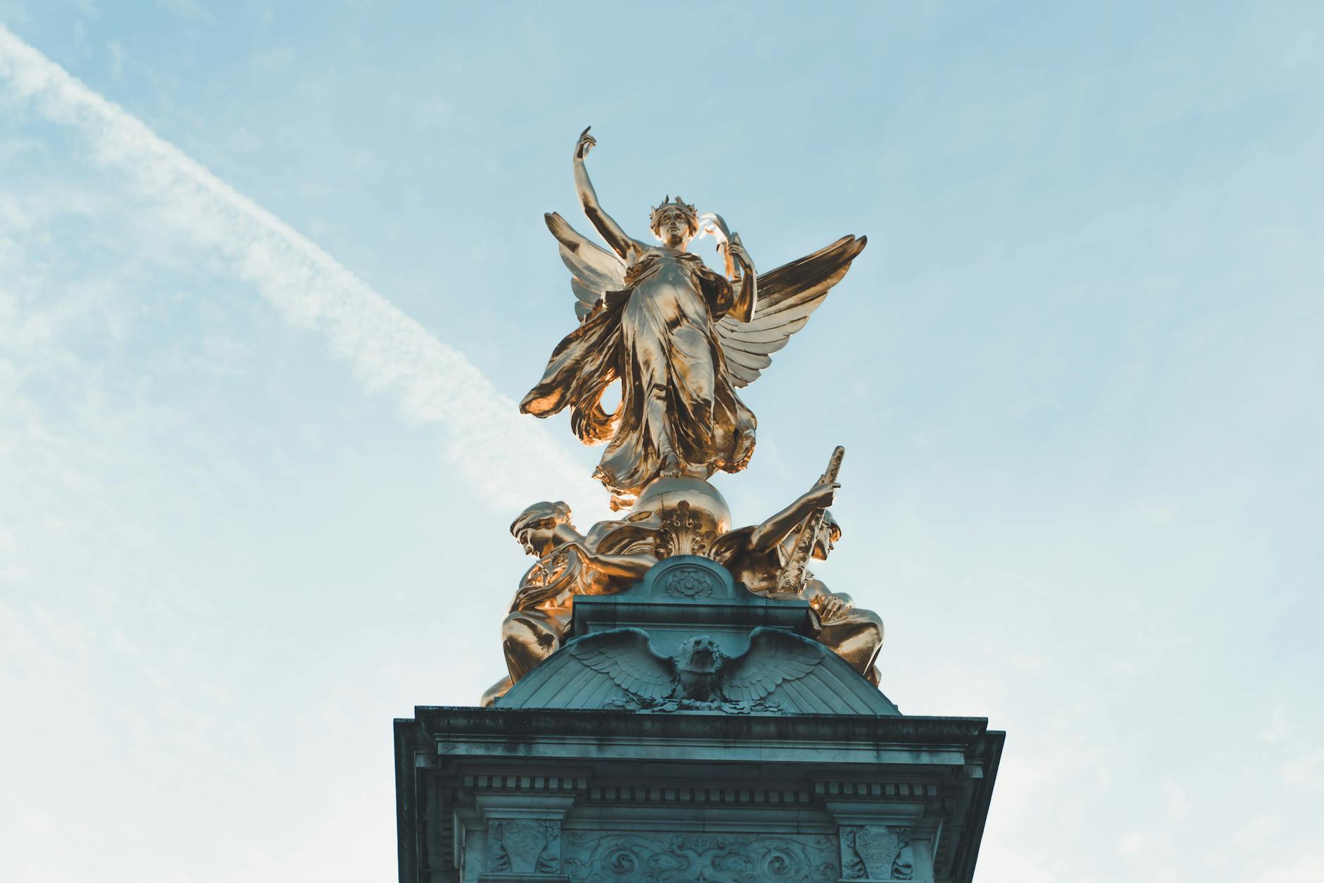 Golden statue atop the Victoria Memorial in London, captured from a low angle with a clear sky backdrop. – Victoria's Secret locations hidden