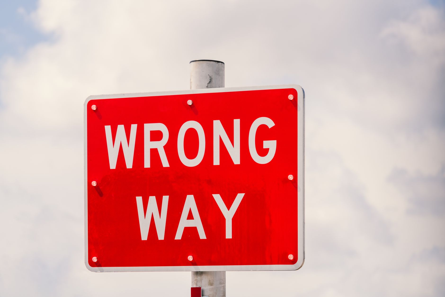 Clear image of a bright red 'Wrong Way' traffic sign against a cloudy sky in Miami, Florida. – Is It Wrong to Try to Pick Up Girls in a Dungeon?